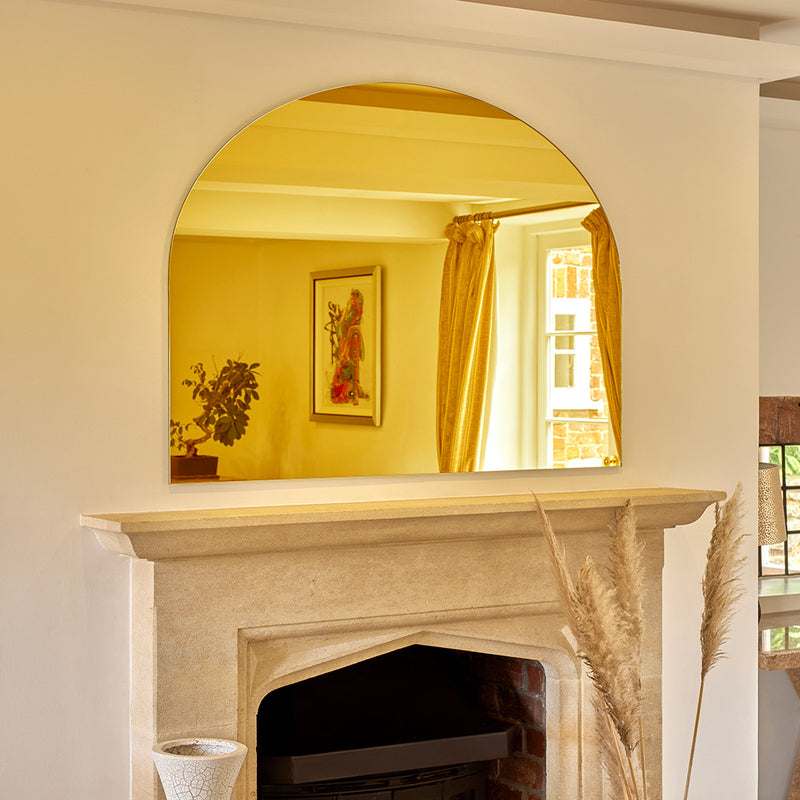 Golden arch mirror takes pride of place over the mantle