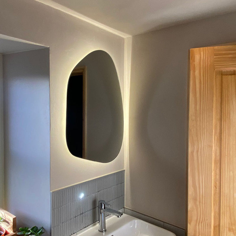 Break up the straight lines in your bathroom with an asymmetrical mirror