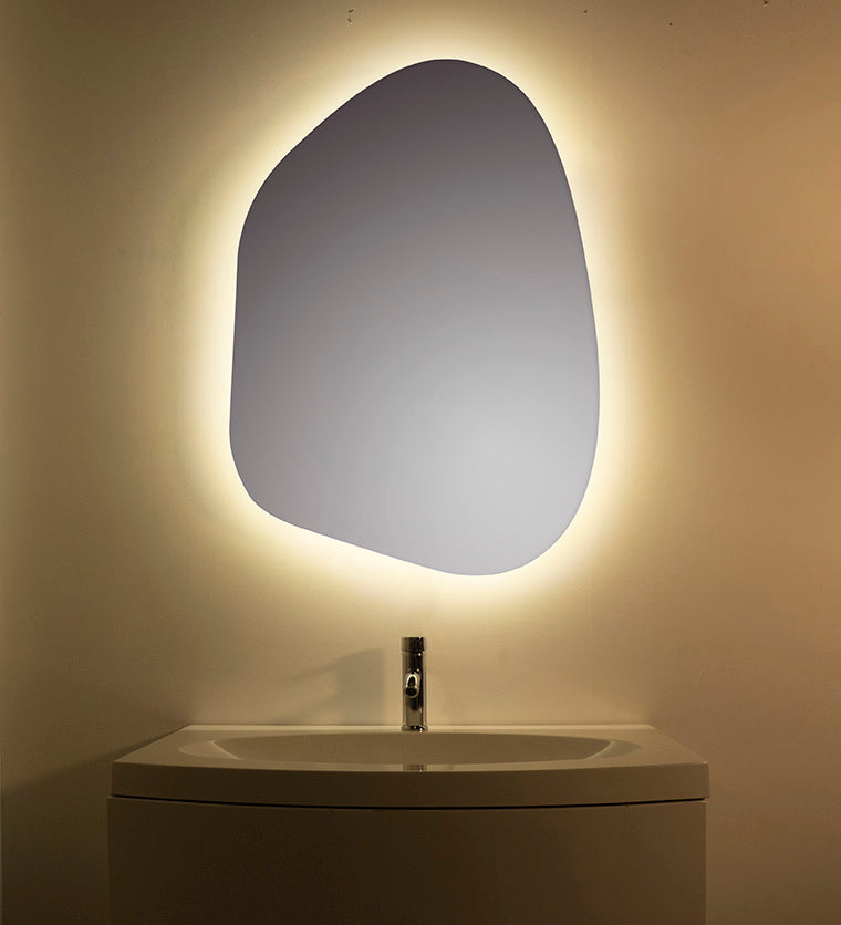 A unique pebble-shaped backlit mirror with hand-crafted curves and warm LEDs