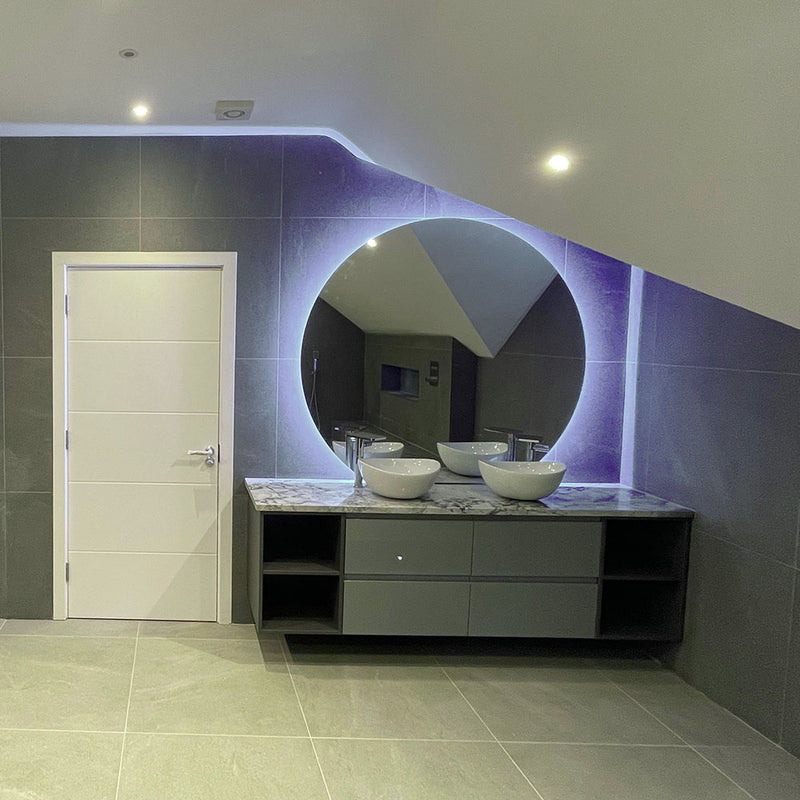 Wonderfully modern bathroom with a bespoke 1200mm dia. backlit circle mirror