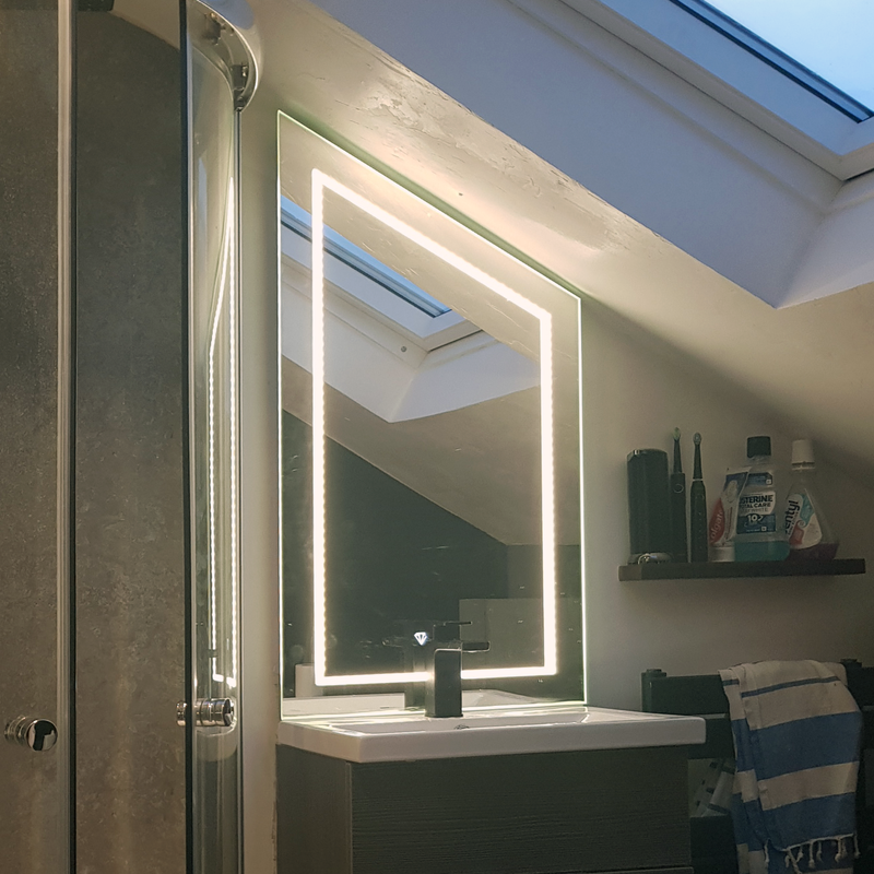 Trapezium shaped LED mirror for a loft conversion ensuite