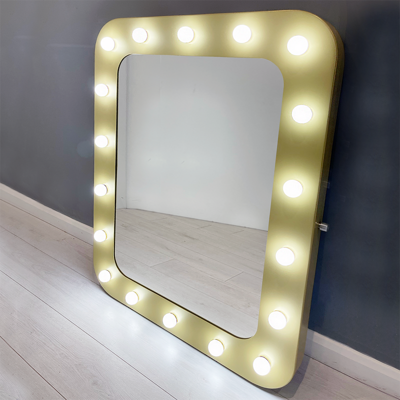 Wonderfully unique Hollywood mirror with a gold metal frame and curved corners