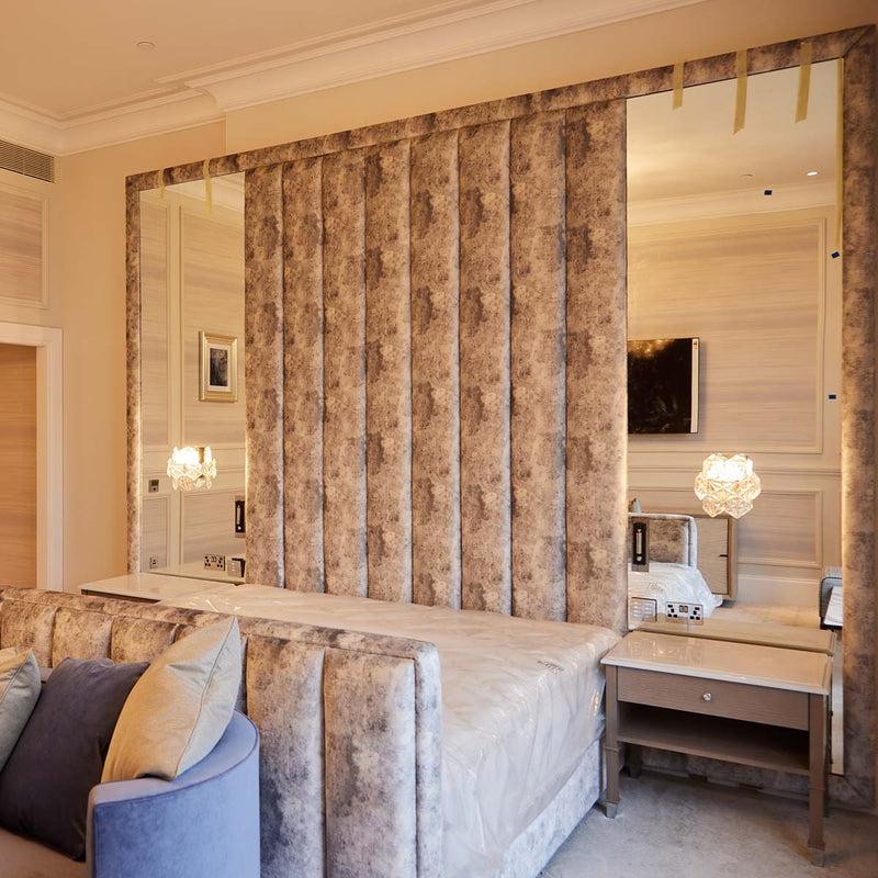 Handcut, 6mm mirror panels integrated in to the headboard in this luxury suite
