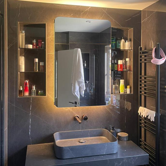 Beautifully backlit bathroom cabinet with handcrafted radius corners