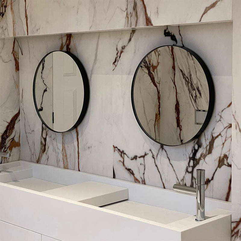 A pair of circular, framed mirrors perfectly finishes this bathroom