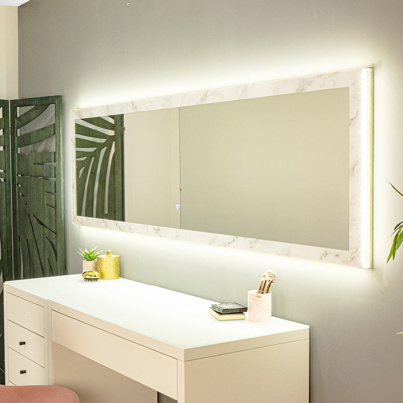 Backlit mirror with a white marble-print frame.